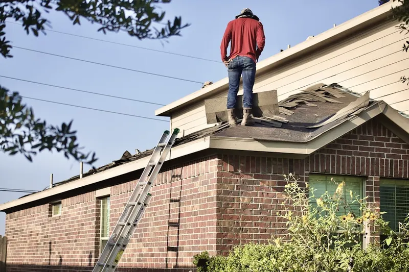 Professional roofer working on a residential roof in Edgewater Gardens